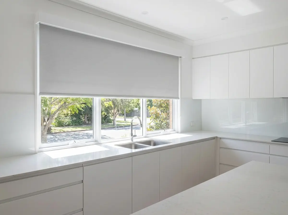 Motorised roller blind retracted halfway above a Morningside kitchen sink window